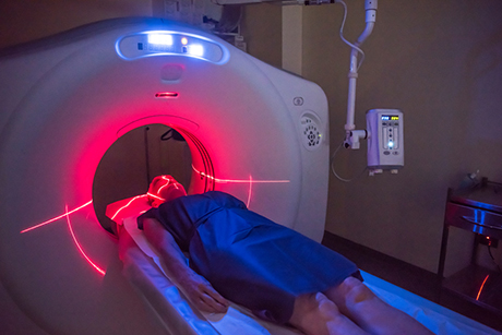 Pictured is a patient undergoing an imaging procedure in an open MRI machine.