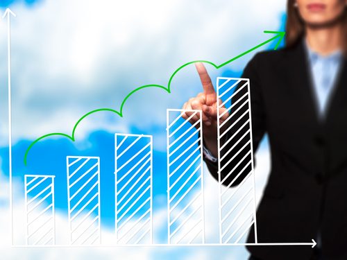 A business professional photo illustration with a bar graph and clouds.
