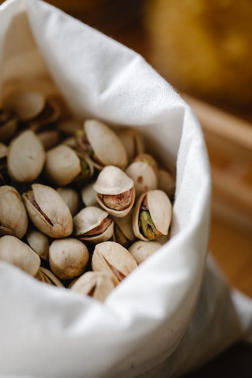 A bag of pistachios in shells.