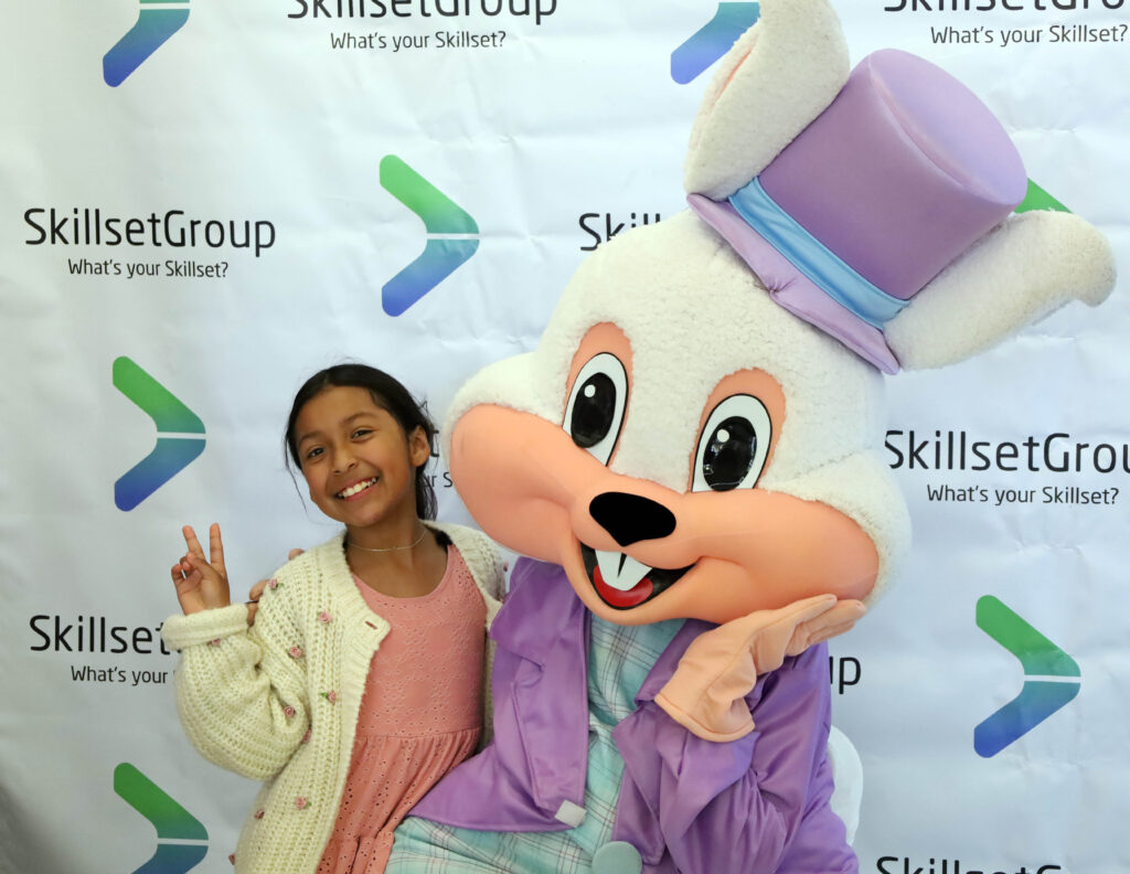 A local Paramount kid poses with the Easter Bunny at the annual basket giveaway hosted by SkillsetGroup and SkillsetGives.
