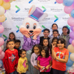 Paramount kids pose with the Easter Bunny. SkillsetGives/SkillsetGroup Easter basket Giveaway. Paramount, 2023.