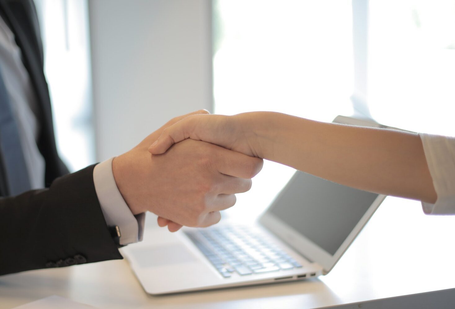 Two professionals shaking hands at an interview