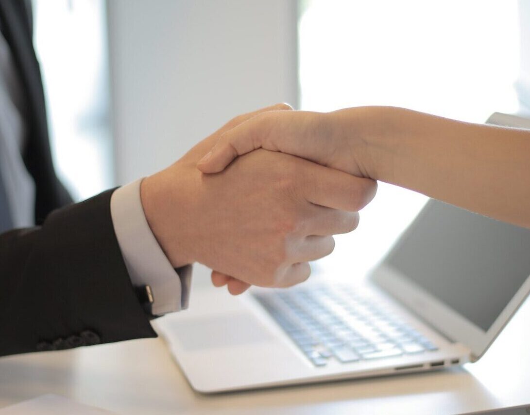 Two professionals shaking hands at an interview
