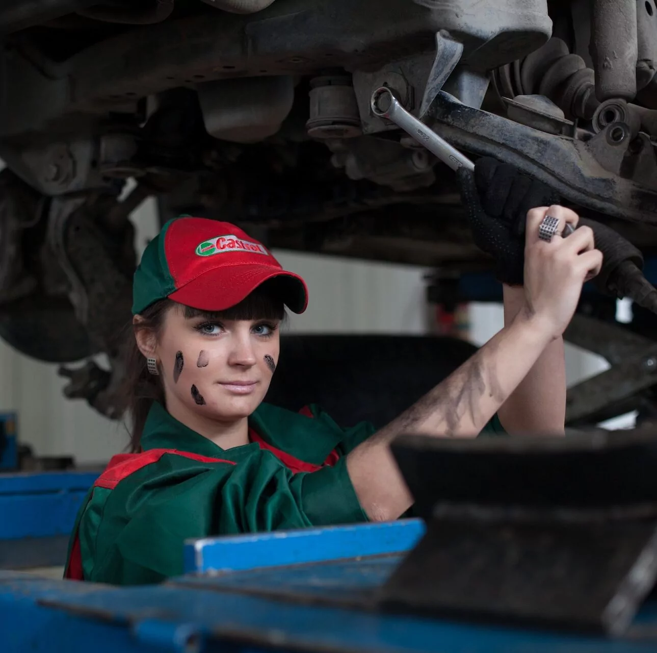 A woman performing an automotive trade job