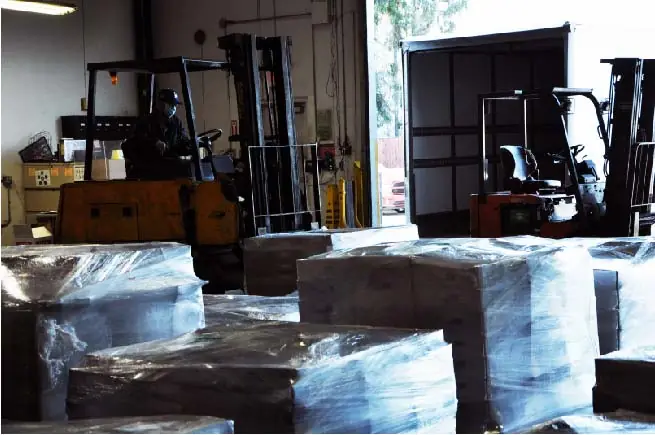 A forklift certified driver moving palettes