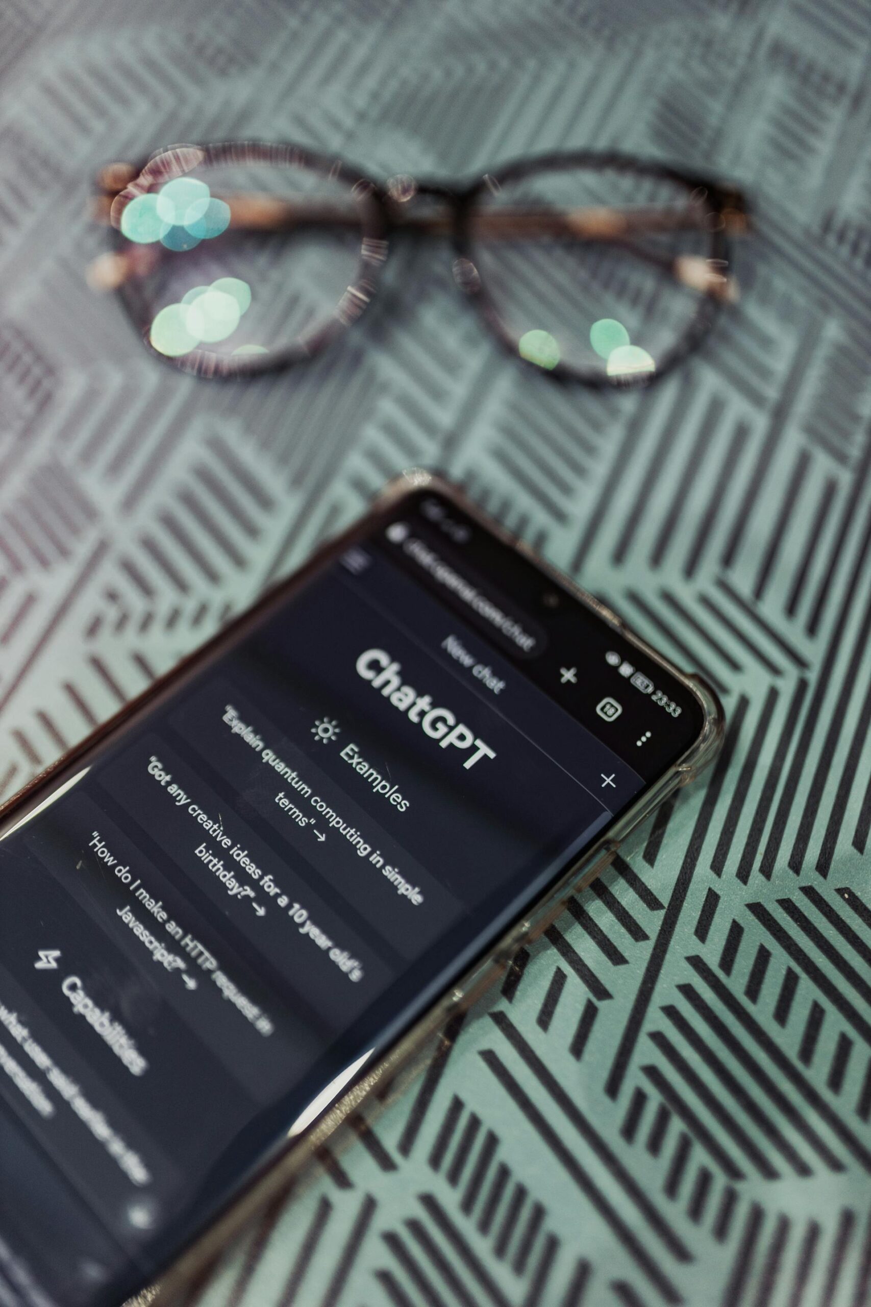 ChatGPT open with a pair of glasses nearby. Will AI replace human jobs?